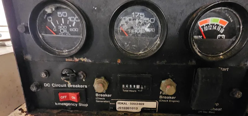 Slide: The Image of Control panel of a 2002 Pursuit 3800 Express boat with gauges and circuit breakers. - 33