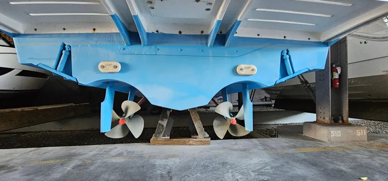 Slide: The Image of Underside view of a 2002 Pursuit 3800 Express boat with dual propellers. - 38