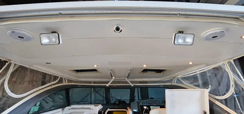 Slide: The Image of 2002 Pursuit 3800 Express boat interior with ceiling lights and dashboard view. - 6