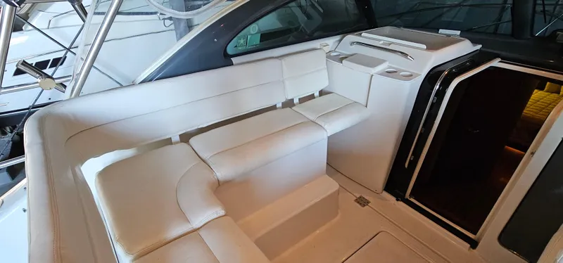 Slide: The Image of 2002 Pursuit 3800 Express yacht interior with white seating and cabin entrance. - 7