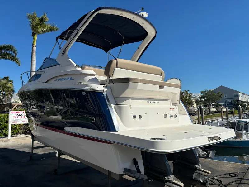 Slide: The Image of 2016 Regal 30 Express boat on display, featuring sleek design and spacious deck. - 10