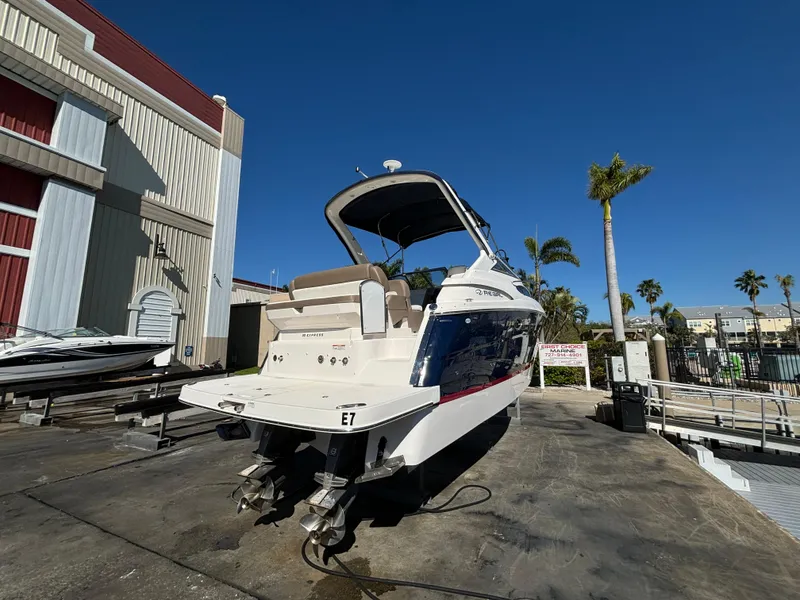 Slide: The Image of 2016 Regal 30 Express boat docked, showcasing sleek design and dual propellers. - 4