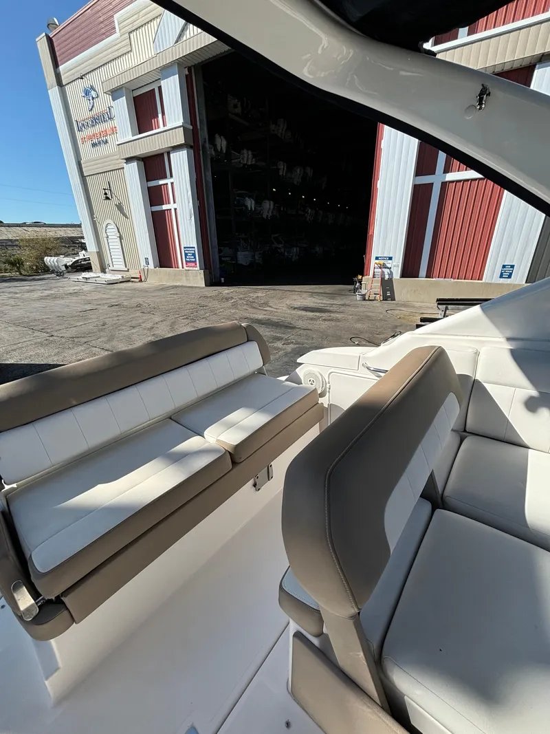 Slide: The Image of 2016 Regal 30 Express boat interior with seating, near a large open garage. - 6