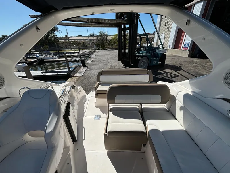 Slide: The Image of 2016 Regal 30 Express boat interior with white seating and open deck view. - 7