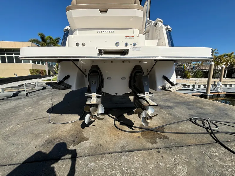 Slide: The Image of 2016 Regal 30 Express boat stern view with dual propellers on a sunny day. - 9