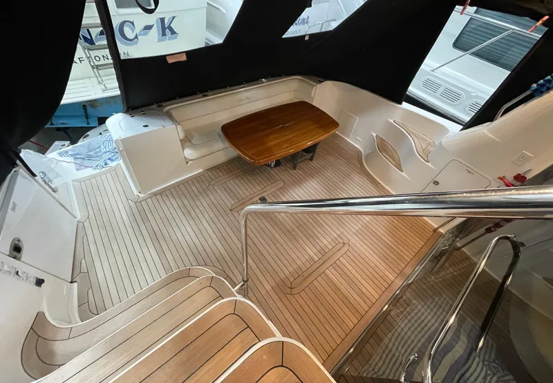 Slide: The Image of 2009 Sea Ray 580 Sedan Bridge yacht interior with teak flooring and seating area. - 14