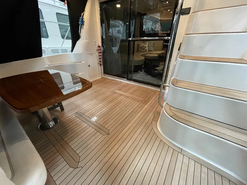 Slide: The Image of 2009 Sea Ray 580 Sedan Bridge yacht interior with wooden deck and elegant seating area. - 16