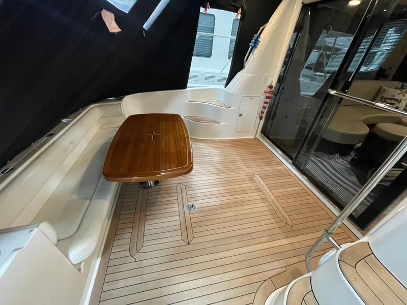 Slide: The Image of 2009 Sea Ray 580 Sedan Bridge yacht interior with wooden flooring and seating area. - 17