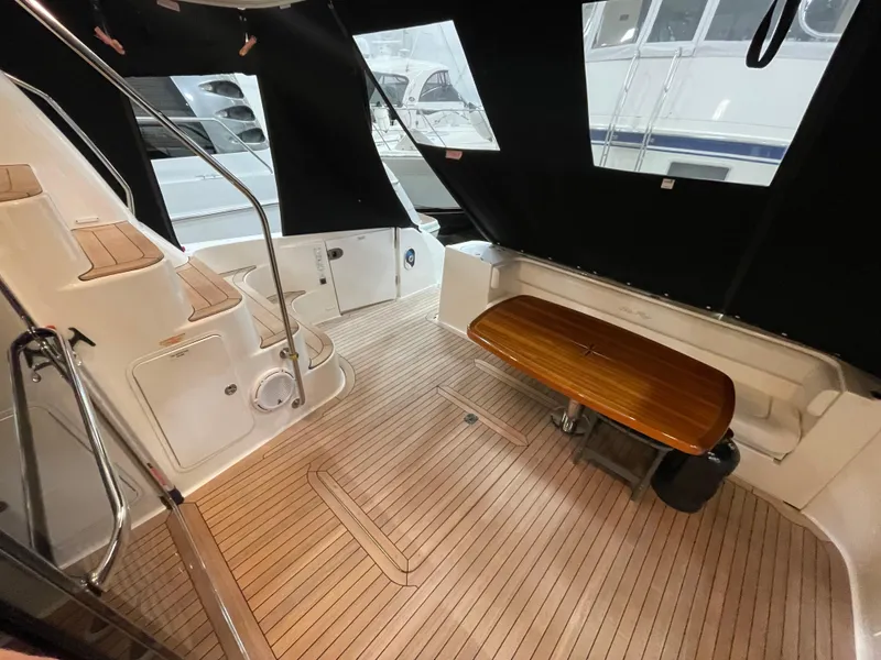 Slide: The Image of 2009 Sea Ray 580 Sedan Bridge yacht interior with wooden flooring and seating area. - 18