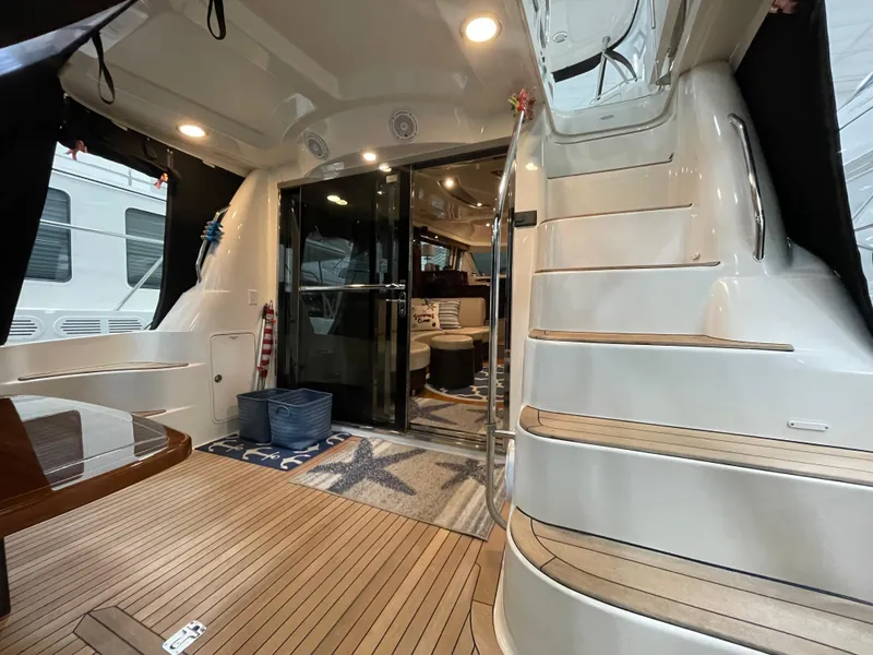 Slide: The Image of 2009 Sea Ray 580 Sedan Bridge yacht interior with elegant wooden flooring and staircase. - 19