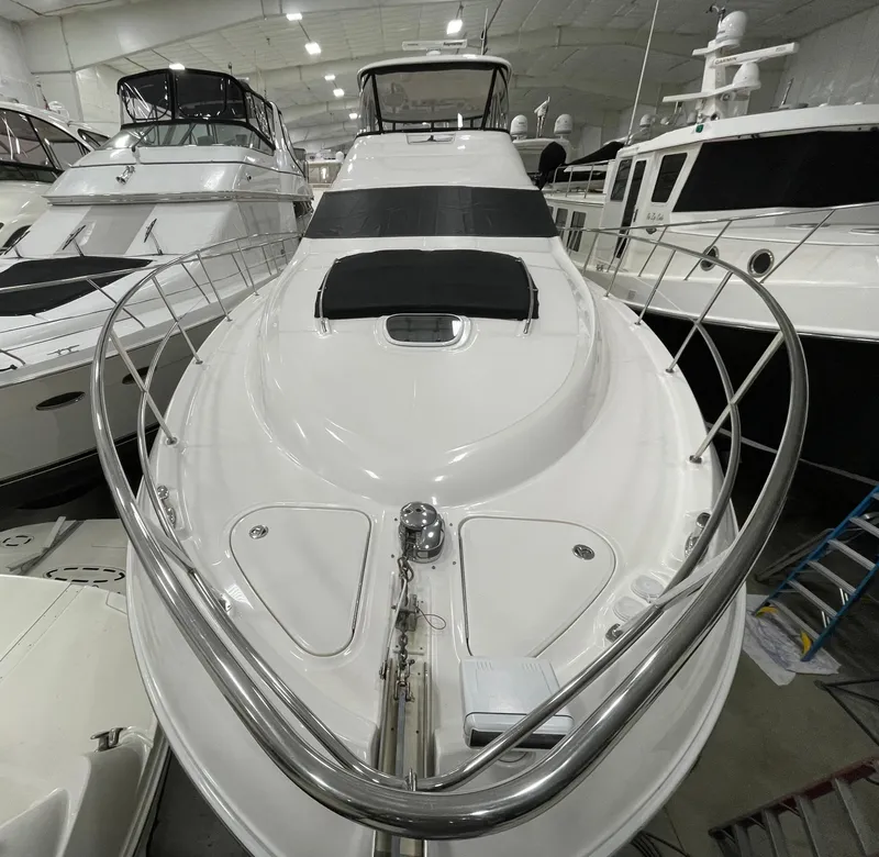 Slide: The Image of 2009 Sea Ray 580 Sedan Bridge yacht in a showroom, showcasing sleek design and luxury features. - 22