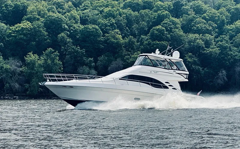 Slide: The Image of 2009 Sea Ray 580 Sedan Bridge yacht cruising on a scenic river. - 25