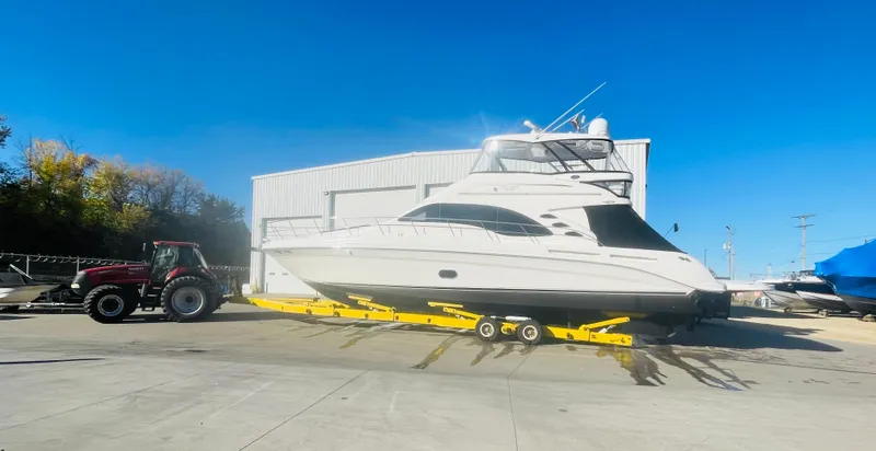Slide: The Image of 2009 Sea Ray 580 Sedan Bridge yacht on trailer, parked outdoors. - 26
