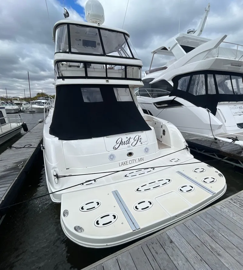 Slide: The Image of 2009 Sea Ray 580 Sedan Bridge yacht docked at marina under cloudy skies. - 27