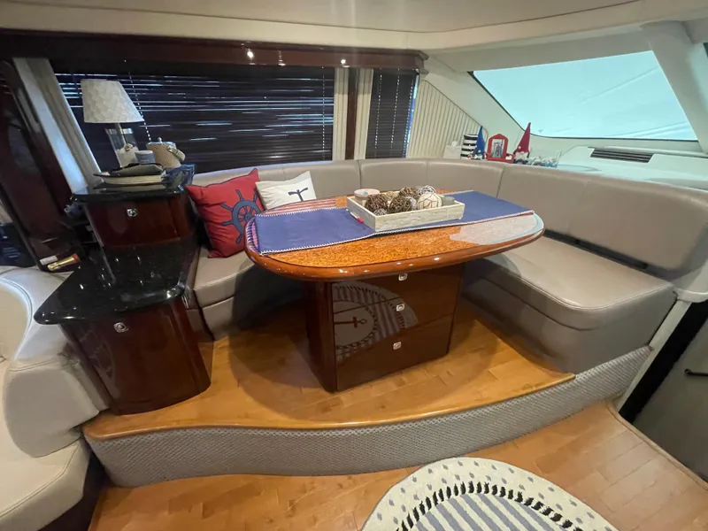 Slide: The Image of Luxurious 2009 Sea Ray 580 Sedan Bridge yacht interior with elegant seating and wooden table. - 32