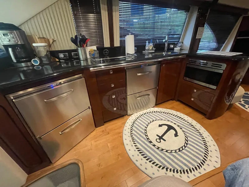 Slide: The Image of Luxurious kitchen interior of 2009 Sea Ray 580 Sedan Bridge yacht with modern appliances. - 33
