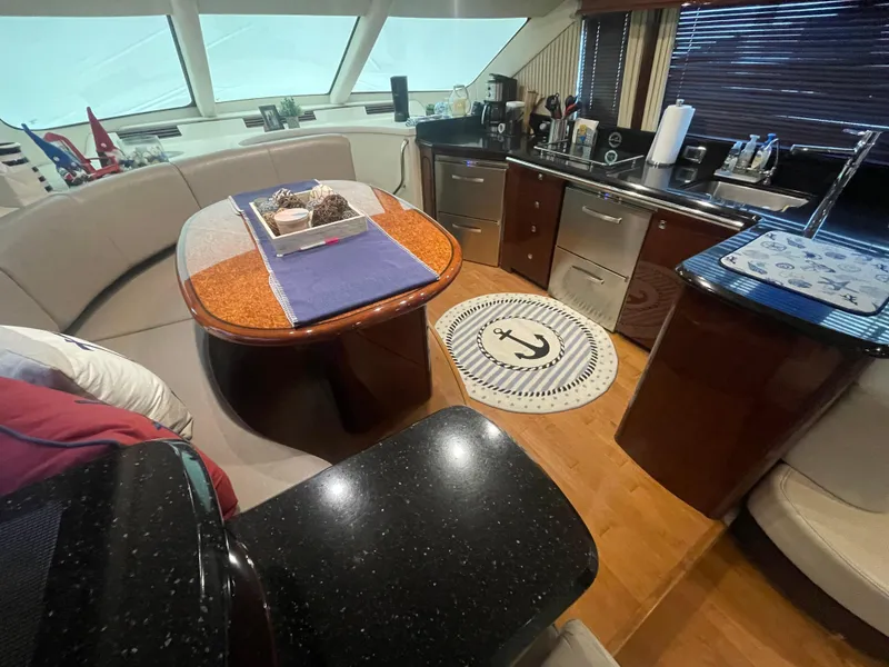 Slide: The Image of Luxurious interior of 2009 Sea Ray 580 Sedan Bridge yacht with modern kitchen and dining area. - 34