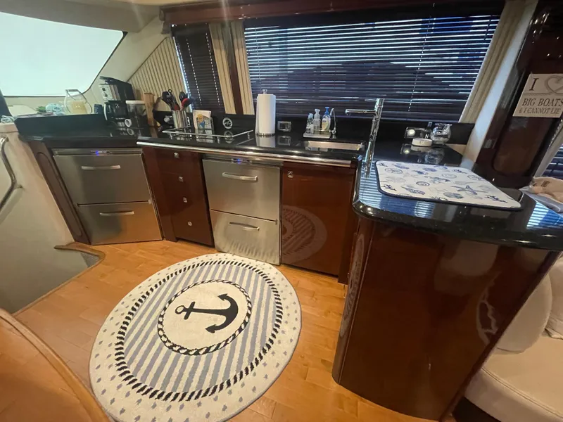 Slide: The Image of Luxurious kitchen interior of 2009 Sea Ray 580 Sedan Bridge yacht with nautical-themed decor. - 36