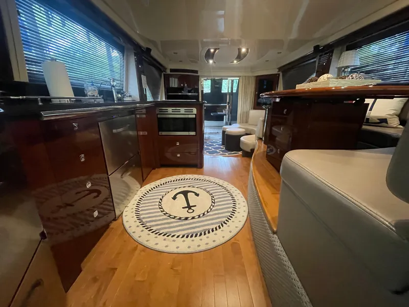 Slide: The Image of Luxurious interior of 2009 Sea Ray 580 Sedan Bridge yacht with elegant wood flooring. - 38