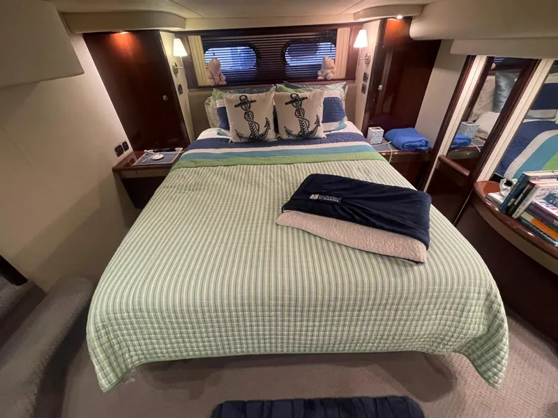Slide: The Image of Luxurious bedroom interior of 2009 Sea Ray 580 Sedan Bridge yacht with nautical decor. - 40