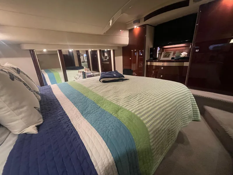 Slide: The Image of Luxurious bedroom interior of 2009 Sea Ray 580 Sedan Bridge yacht with striped bedding. - 41