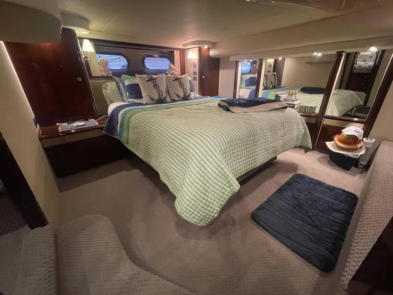 Slide: The Image of Luxurious bedroom interior of 2009 Sea Ray 580 Sedan Bridge yacht, featuring elegant bedding and decor. - 42