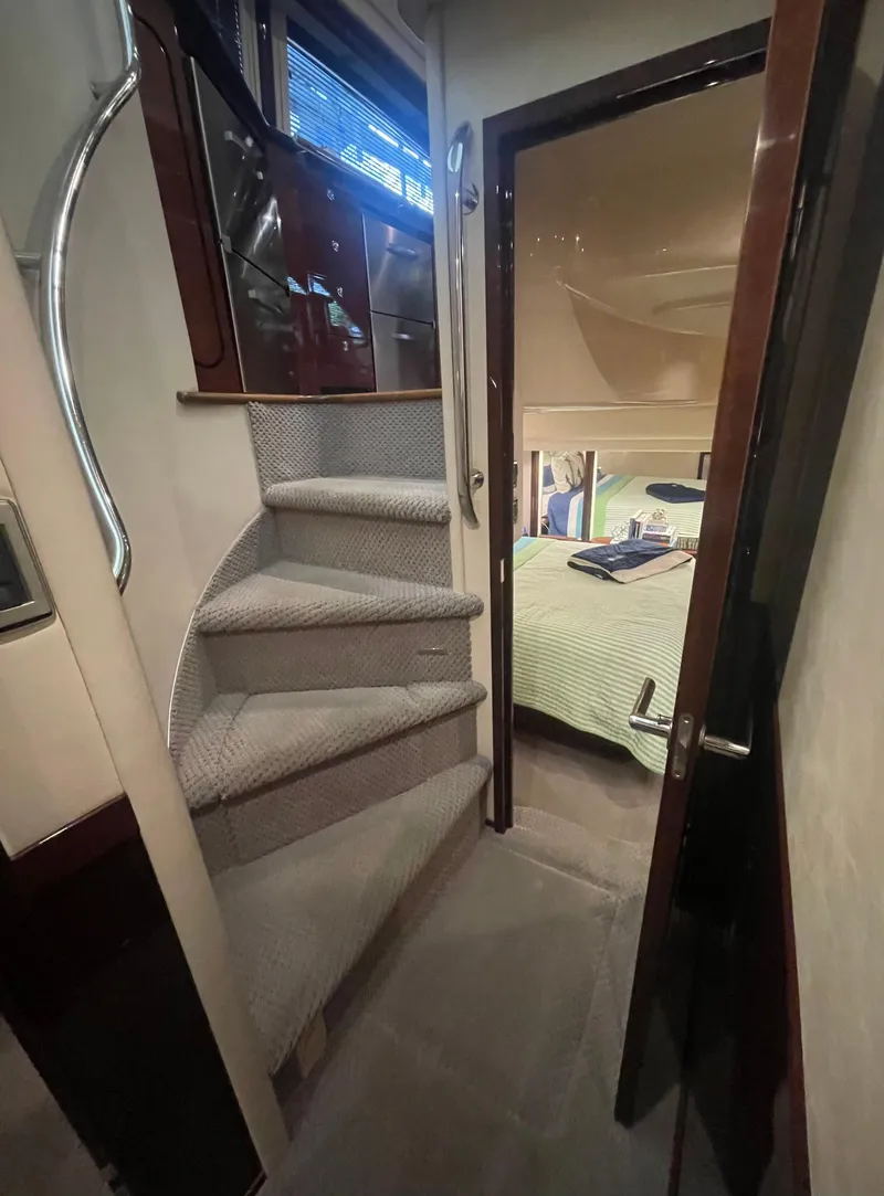 Slide: The Image of Interior of 2009 Sea Ray 580 Sedan Bridge with carpeted stairs and cozy bedroom. - 43