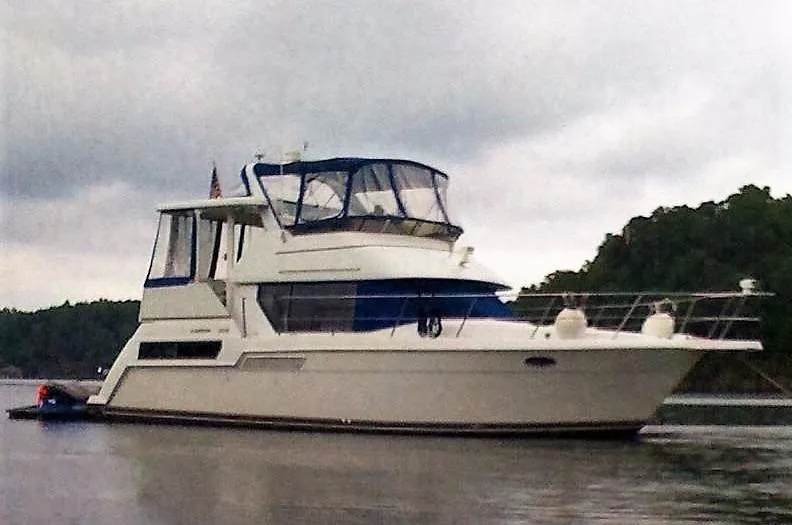 Slide: The Image of 1996 Carver 355 Aft Cabin yacht on calm water, overcast sky. - 1