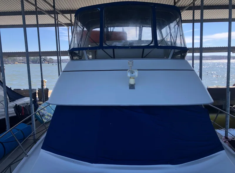 Slide: The Image of 1996 Carver 355 Aft Cabin yacht docked in a marina, front view. - 13