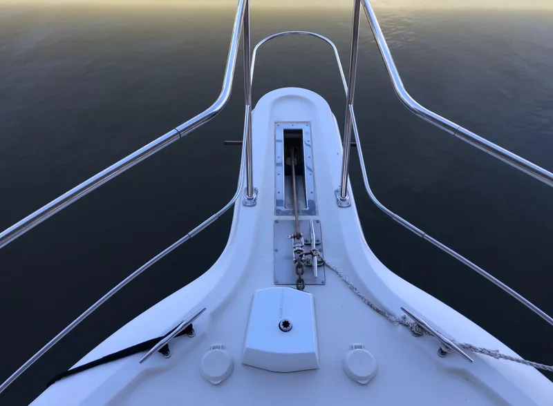 Slide: The Image of Bow of 1996 Carver 355 Aft Cabin yacht with stainless steel railings. - 14