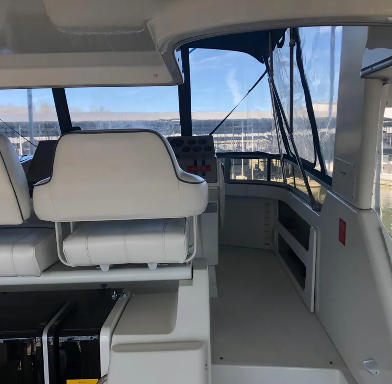 Slide: The Image of Interior view of 1996 Carver 355 Aft Cabin yacht with helm and seating. - 18