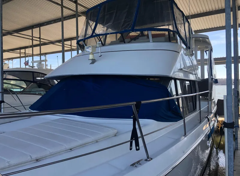 Slide: The Image of 1996 Carver 355 Aft Cabin yacht docked under a covered marina. - 2