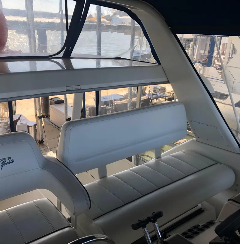 Slide: The Image of 1996 Carver 355 Aft Cabin interior with white seating and large windows. - 23