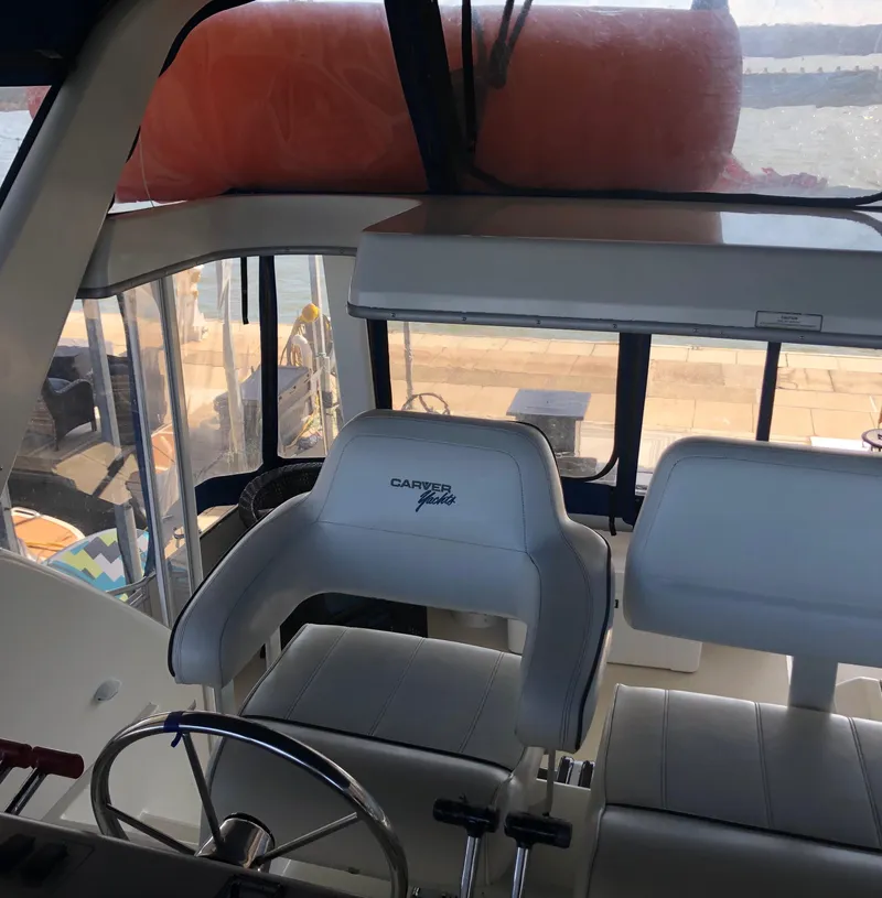 Slide: The Image of Interior of a 1996 Carver 355 Aft Cabin yacht with helm and seating. - 24