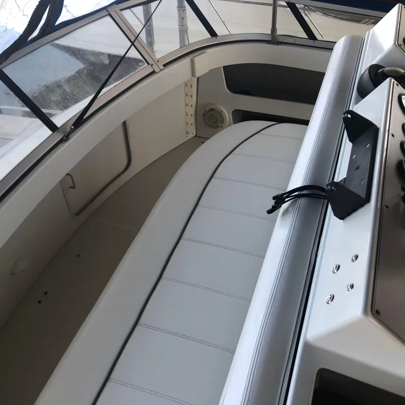 Slide: The Image of 1996 Carver 355 Aft Cabin interior with white seating and control panel. - 25