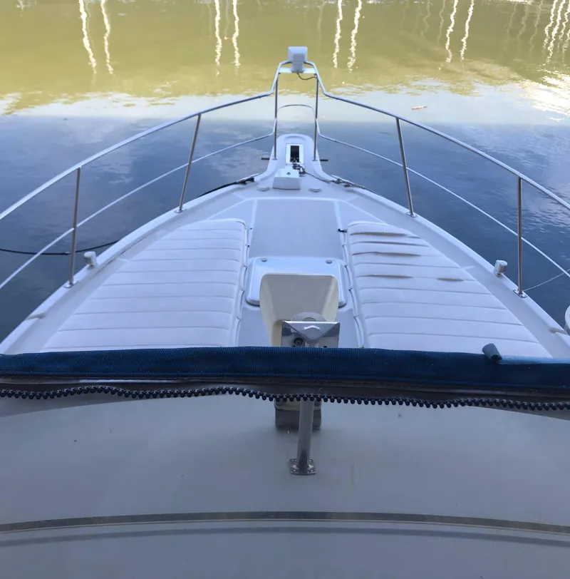 Slide: The Image of 1996 Carver 355 Aft Cabin boat deck with calm water reflection. - 27