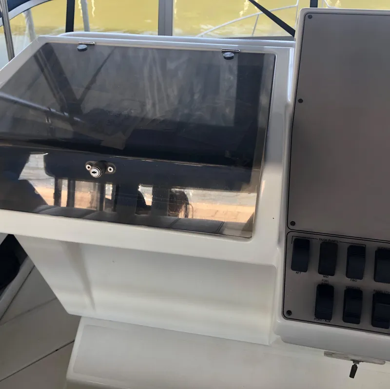 Slide: The Image of 1996 Carver 355 Aft Cabin helm with control panel and switches. - 28