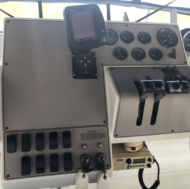 Slide: The Image of Control panel of a 1996 Carver 355 Aft Cabin boat with gauges and switches. - 29