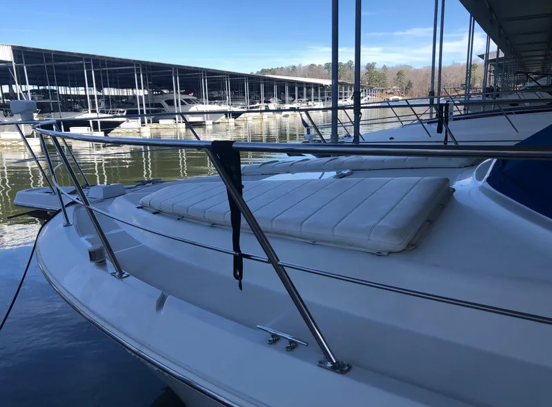 Slide: The Image of 1996 Carver 355 Aft Cabin yacht docked at marina, featuring spacious deck and railing. - 3