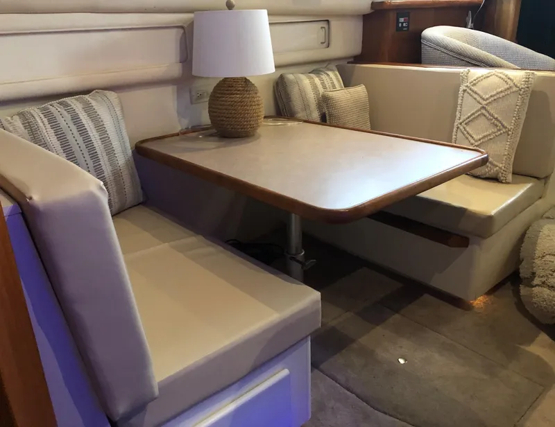 Slide: The Image of 1996 Carver 355 Aft Cabin interior with cozy dining area and stylish decor. - 40