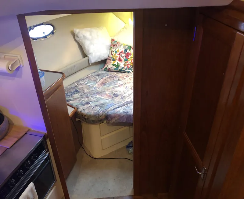 Slide: The Image of Interior of 1996 Carver 355 Aft Cabin with cozy bed and wooden cabinetry. - 43