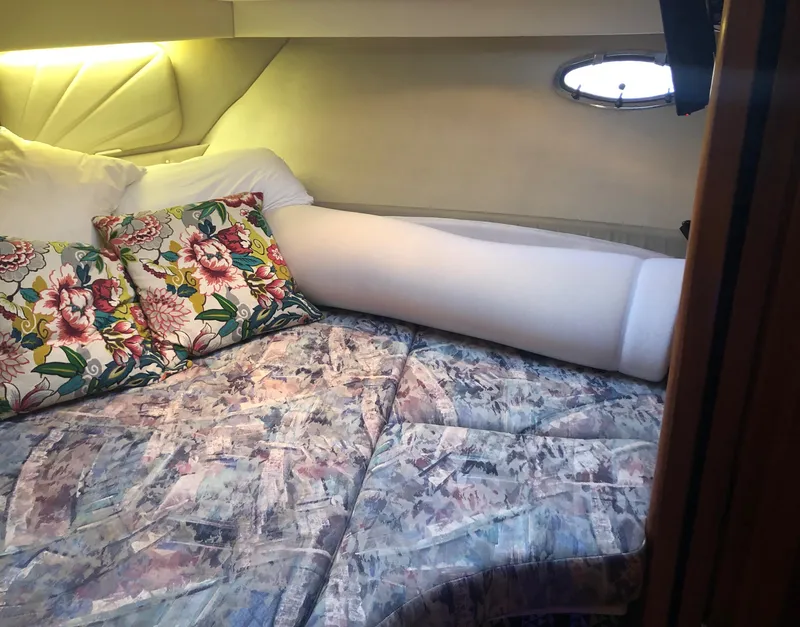 Slide: The Image of 1996 Carver 355 Aft Cabin interior with floral pillows and patterned bedding. - 45