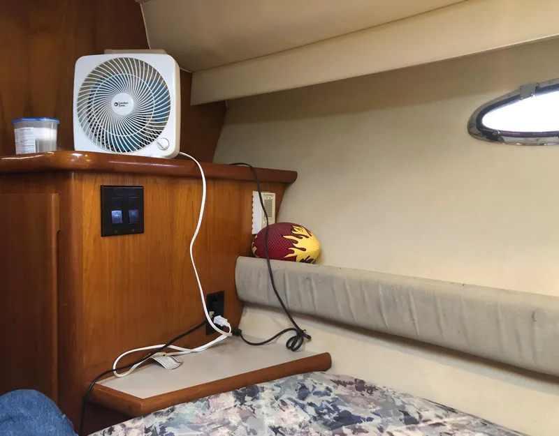 Slide: The Image of Interior of 1996 Carver 355 Aft Cabin with fan, football, and window. - 47