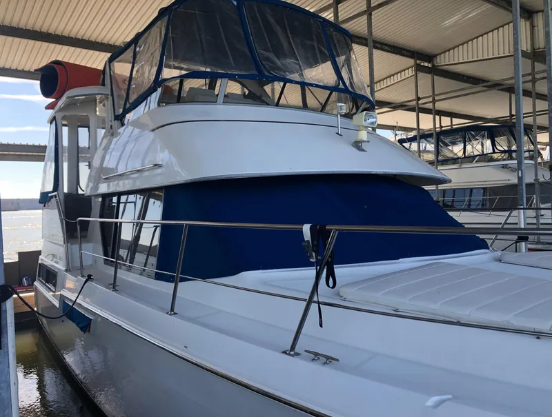 Slide: The Image of 1996 Carver 355 Aft Cabin yacht docked in a covered marina. - 7