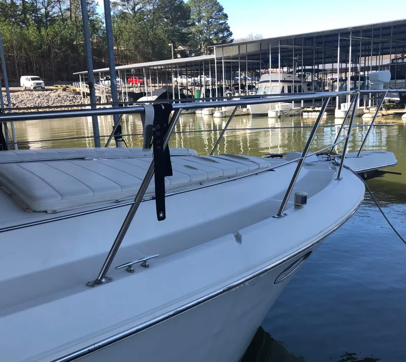 Slide: The Image of 1996 Carver 355 Aft Cabin yacht docked at a marina, surrounded by water and boats. - 9