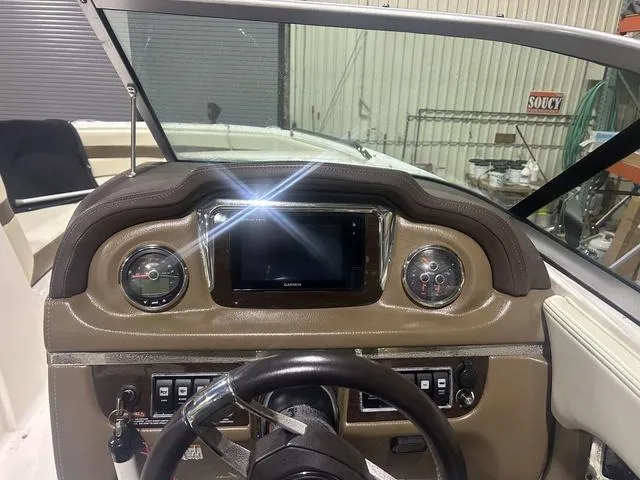 Slide: The Image of 2017 Chaparral 246 SSi boat dashboard with gauges and Garmin display. - 7