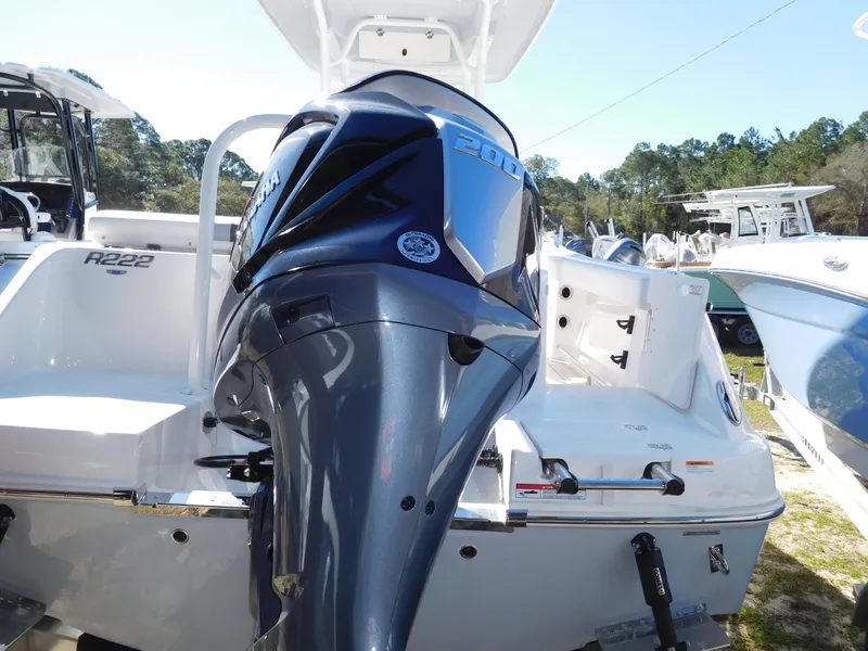 Slide: The Image of 2025 Robalo R222 Center Console boat with powerful outboard motor, displayed outdoors. - 3