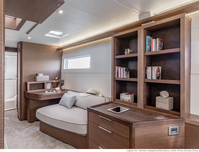 Slide: The Image of Luxurious interior of 2025 Lagoon 46 ICONIC yacht with modern furnishings and built-in bookshelves. - 13