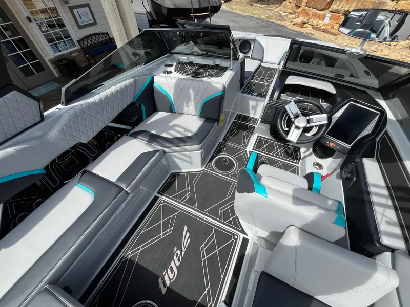 Slide: The Image of 2023 Tigé 22RZX boat interior with modern seating and sleek dashboard design. - 16