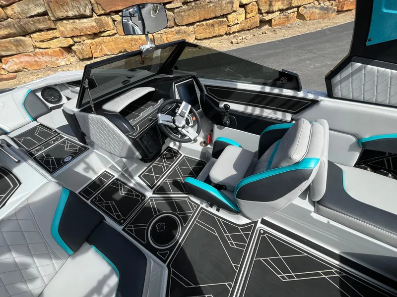 Slide: The Image of 2023 Tigé 22RZX boat interior with modern design, featuring black and teal accents. - 19